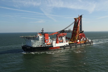 A huge knuckle boom crane does its job on this pipe-laying vessel.